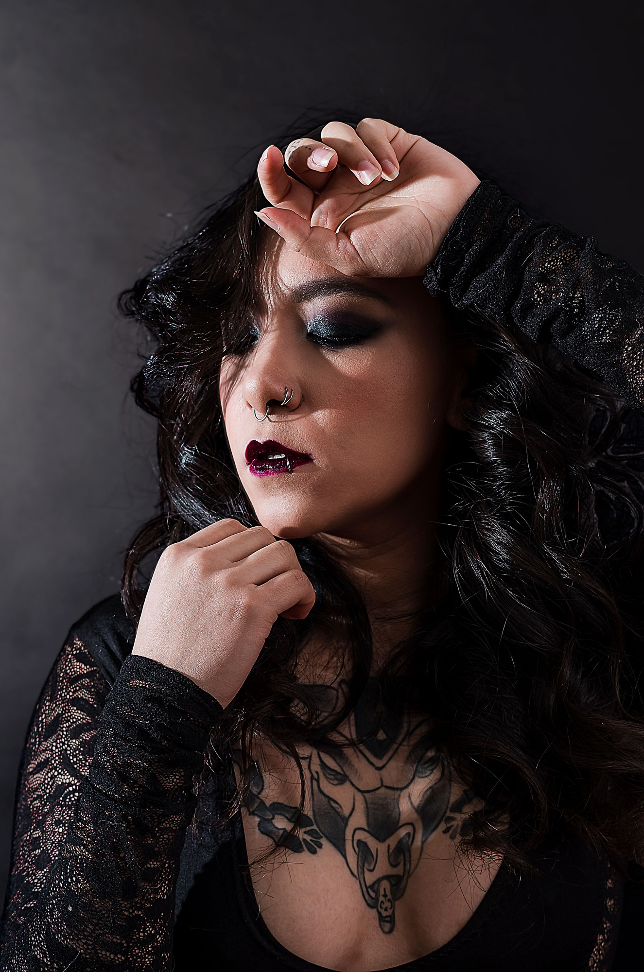 Low-key studio frame with smoke after retouching, shadow detail recovered and lace detail retained