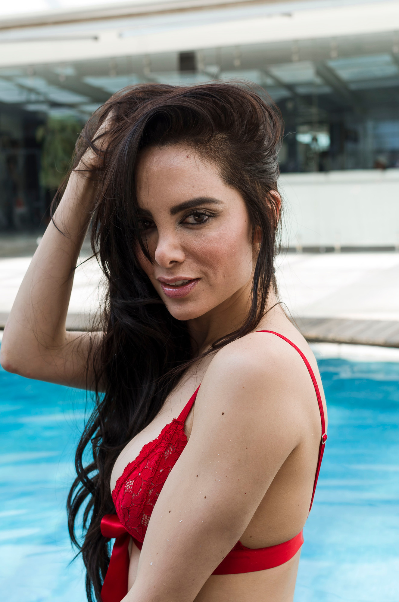 The same poolside frame in natural light before retouching